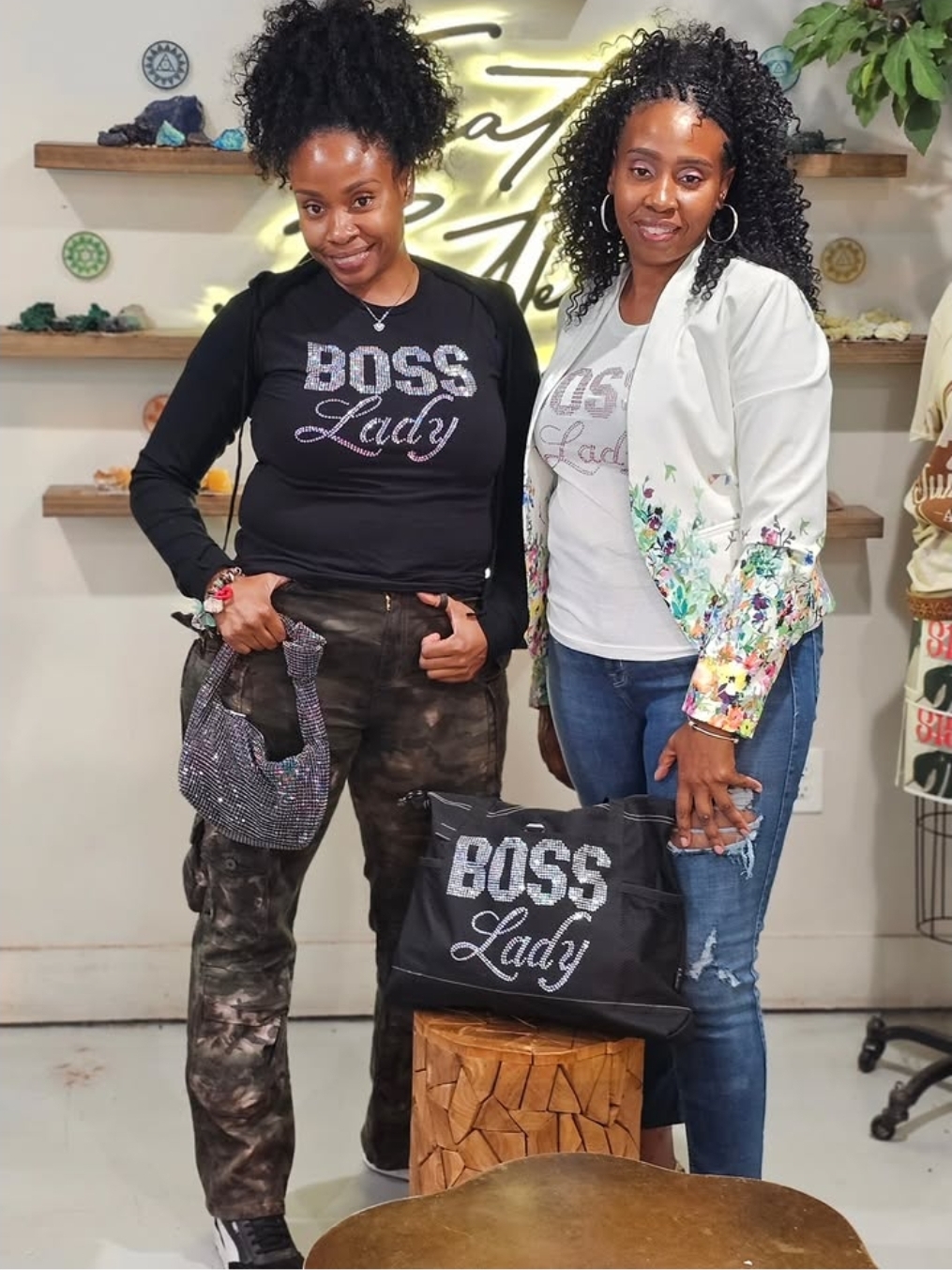 Tracey and Stacey L modeling Boss Lady apparel and accessories inside a boutique